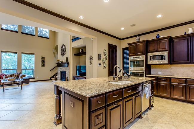 gourmet granite kitchen with stainless steel appliances