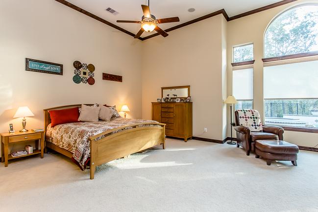 expansive master bedroom with sitting area